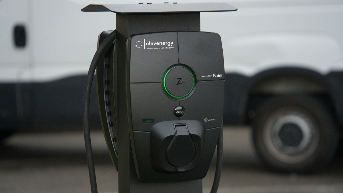 Close-up of an EV charging station unit with cable and connector in an outdoor setting