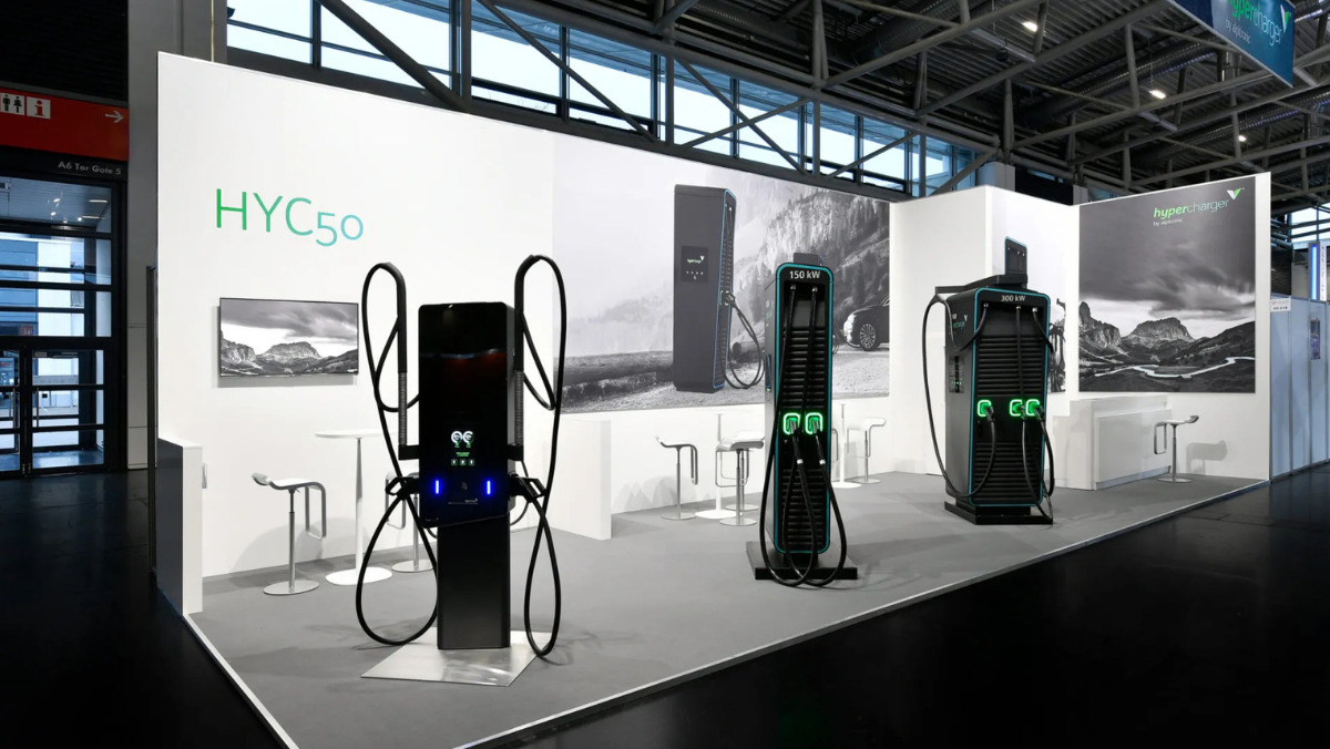 High-power EV chargers displayed in modern exhibition booth with Alpitronic units