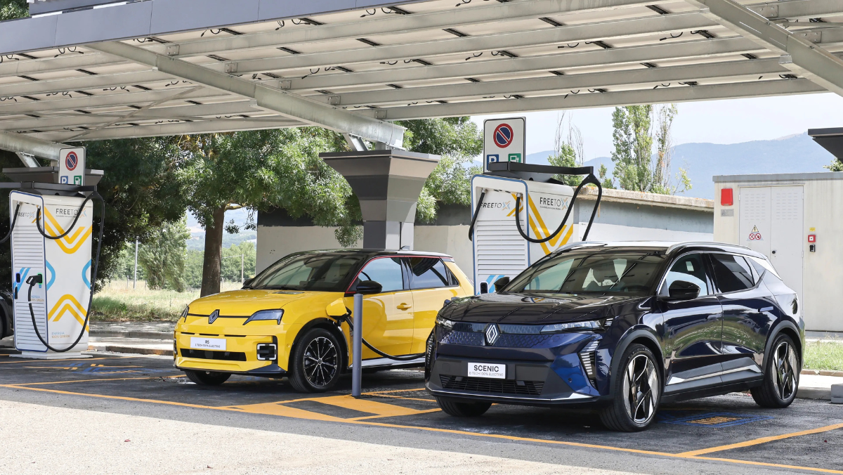 Electric vehicles charging at solar-covered EV station with dual chargers