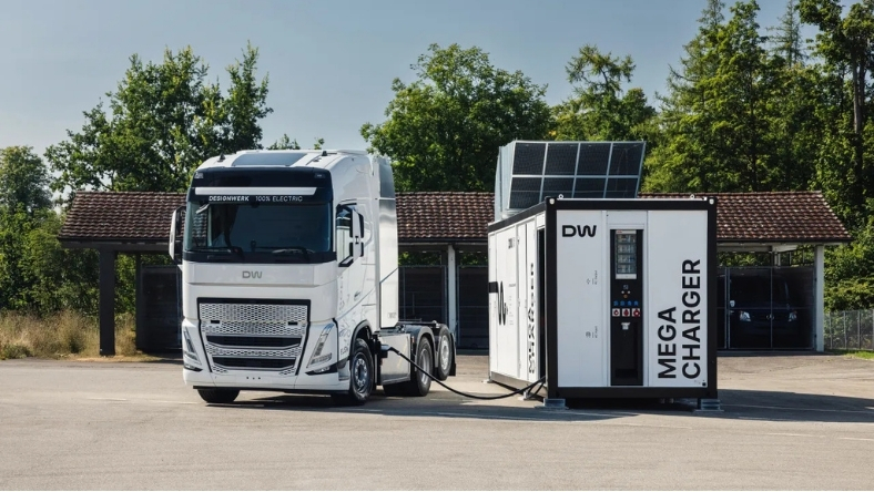 Electric truck connected to a megawatt charging station at a roadside facility