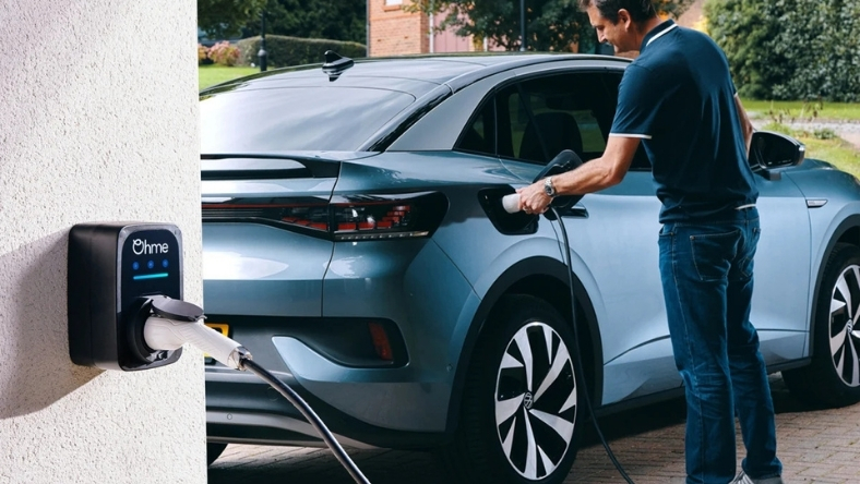 Driver plugging electric car into residential charger