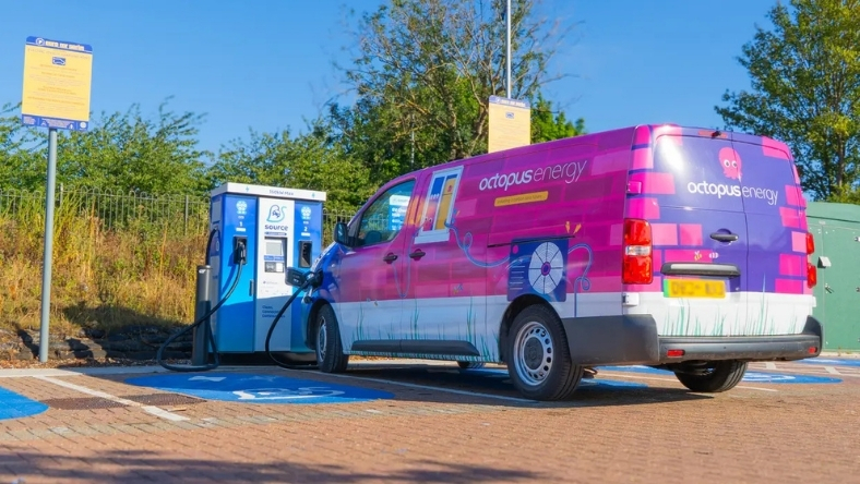 Branded Octopus Energy electric van plugged into public charging point
