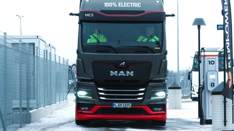 Electric MAN truck charging at high power station in winter