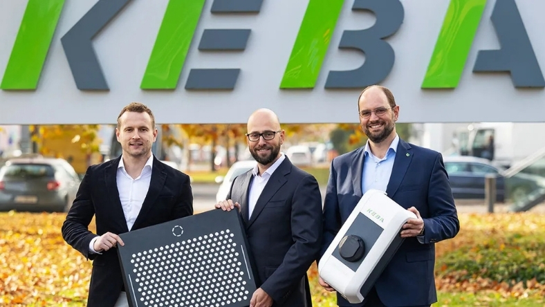 EO Charging and KEBA executives holding EV charging units